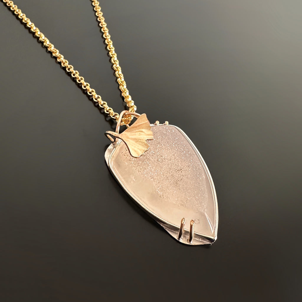 Druzy quartz pendant set in sterling silver and 14k gold filled with a sculpted ginkgo leaf accent and a heavy 14k gold-filled chain.