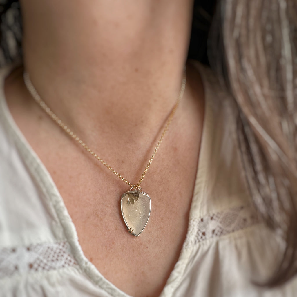 Druzy quartz pendant set in sterling silver and 14k gold filled with a sculpted ginkgo leaf accent and a heavy 14k gold-filled chain. Adjustable length 16"-18".