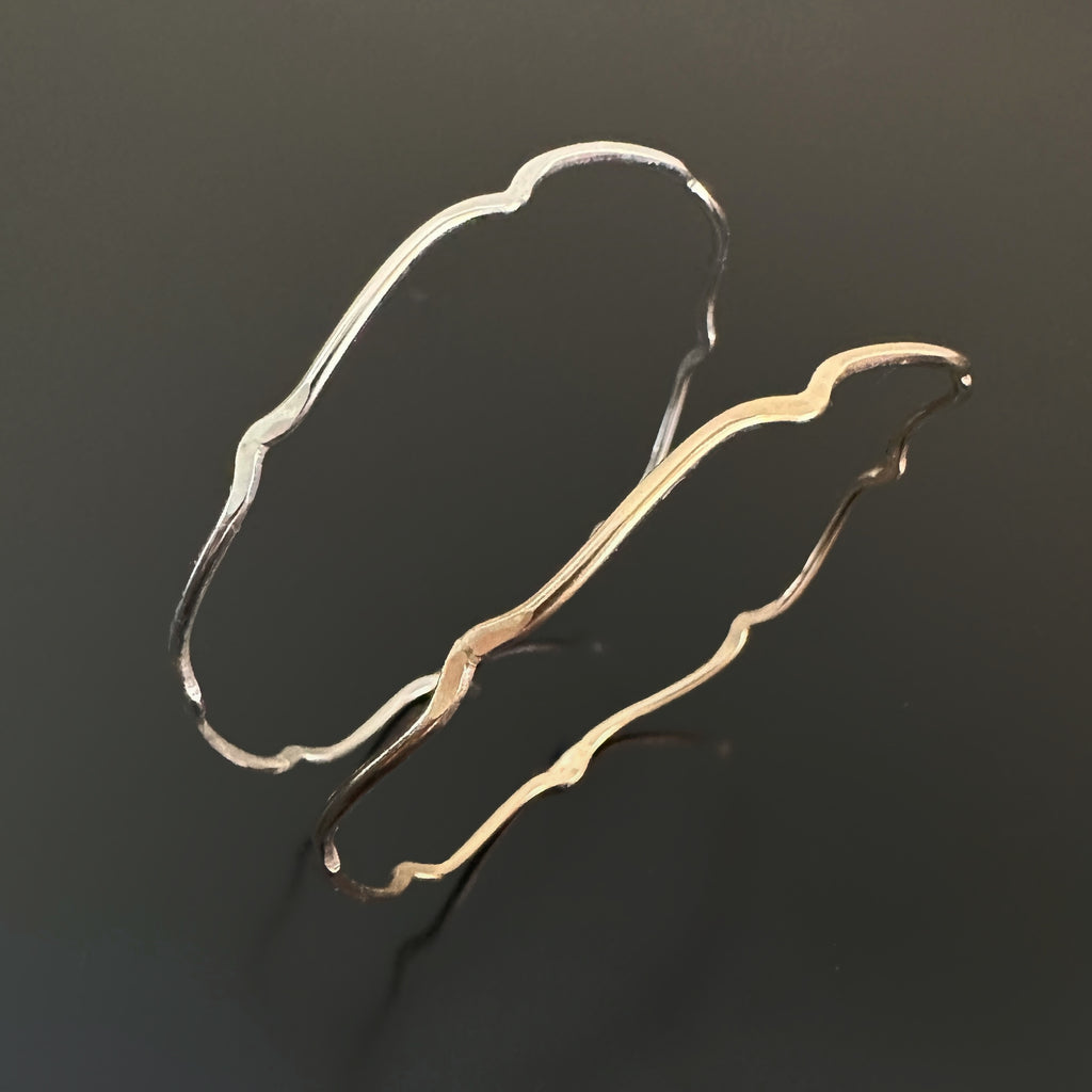 choose either the sterling silver or the 14k gold-filled bangle bracelet with a wavy bracketed parenthesis design.