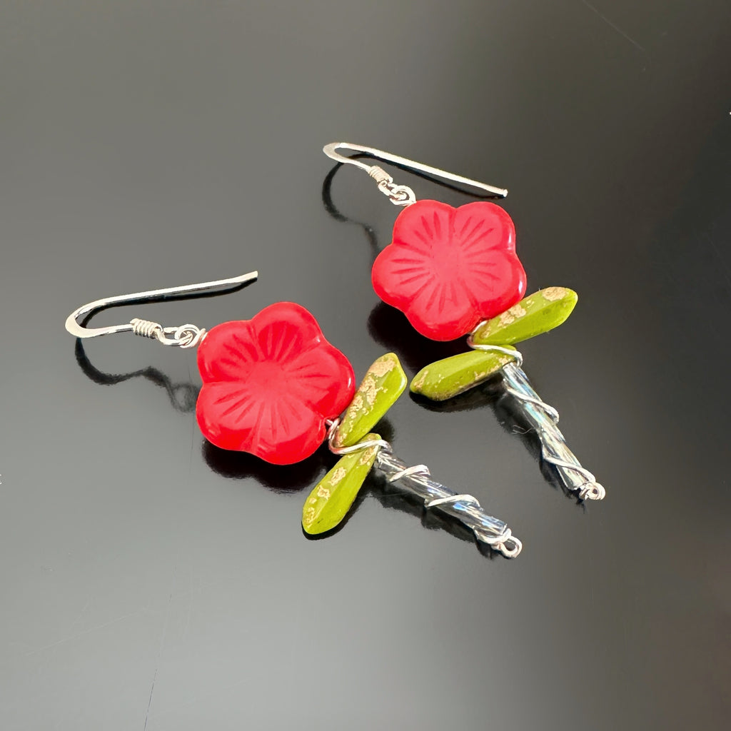 Red Czech glass flower beaded earrings with stem and two leaves.