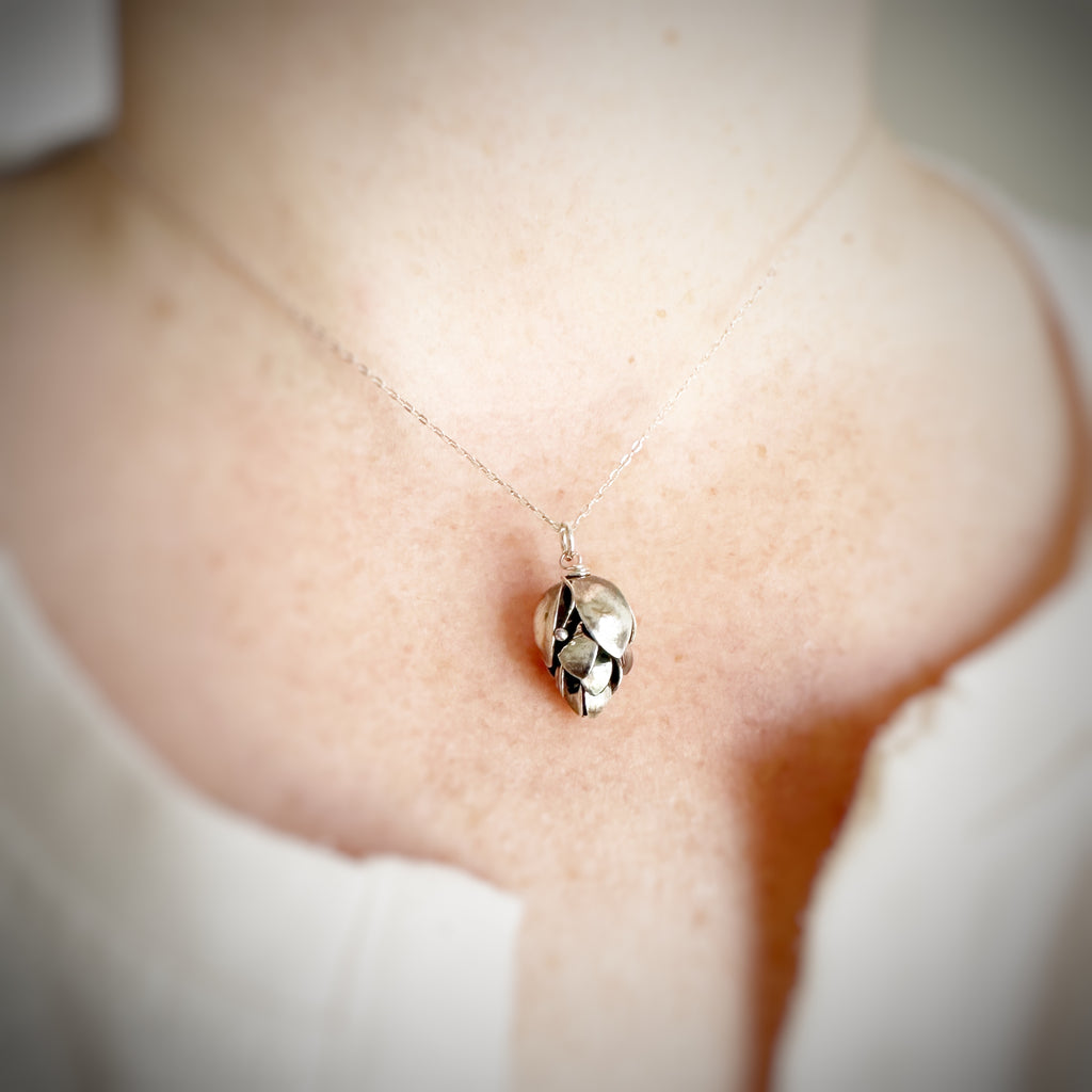 handmade, hammer formed sterling silver hops pendant necklace on a sterling silver adjustable length chain.