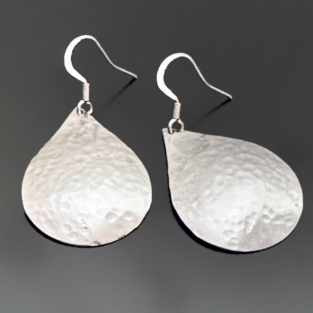Large silvery teardrop dangle earrings with a subtle hammered texture.