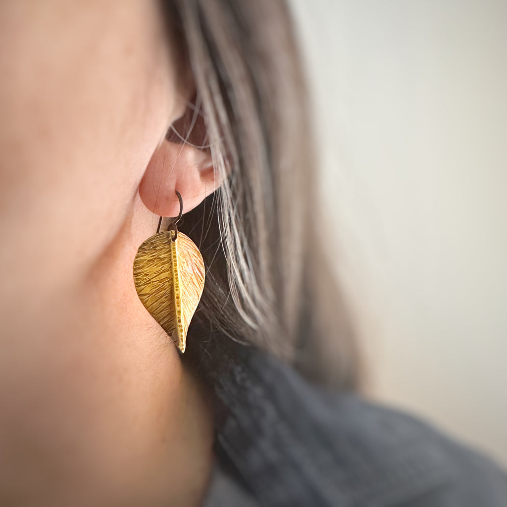 extra large earrings that are hand formed and hammer textured leaves made of oxidized brass