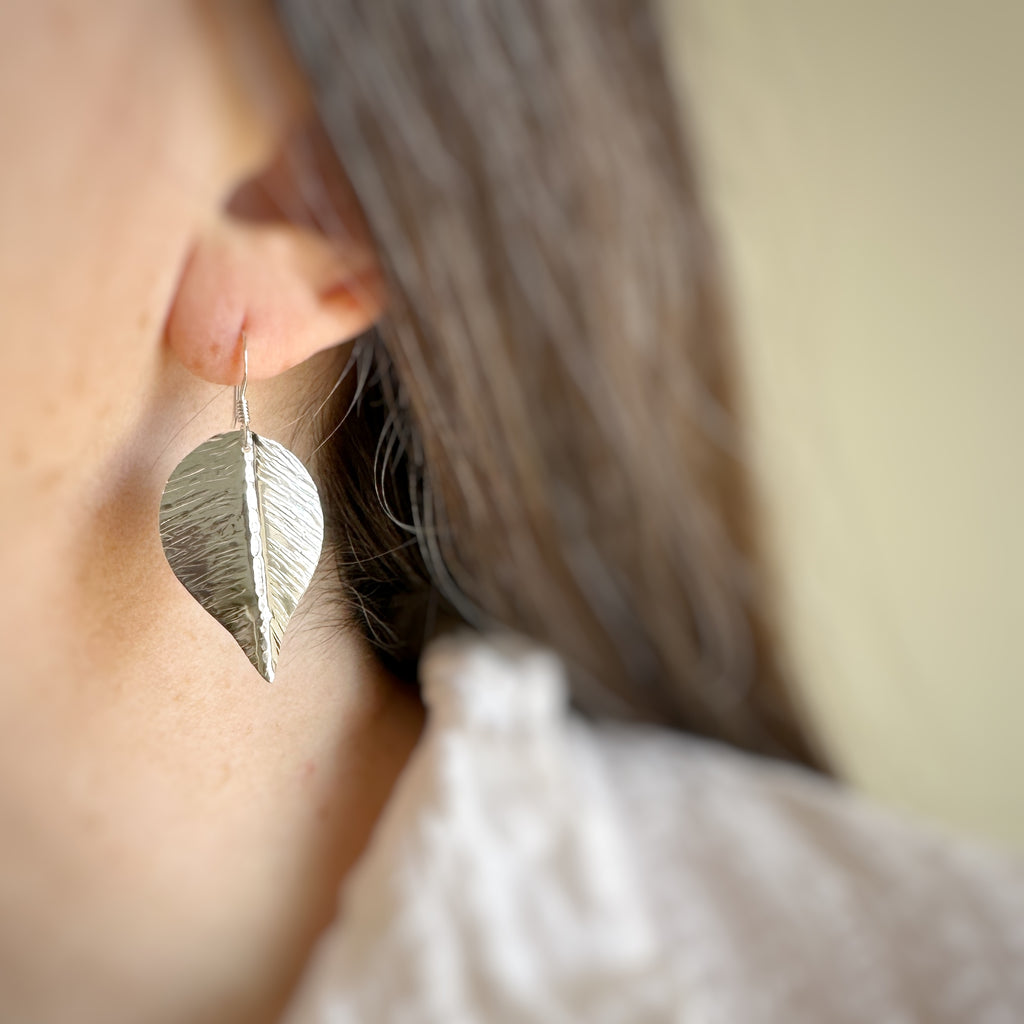 extra large hand formed and hammer textured leaves made of sterling silver.