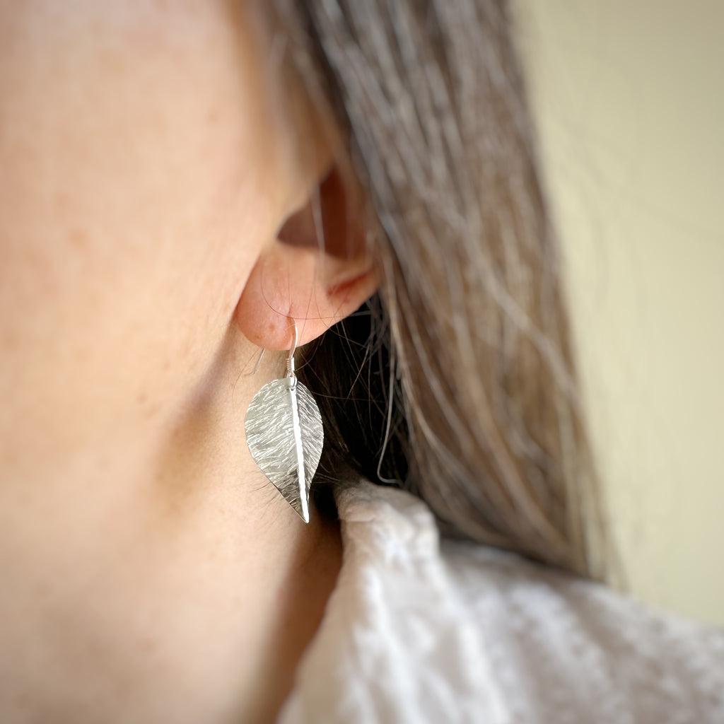 large hand formed and hammer textured leaves made of sterling silver.
