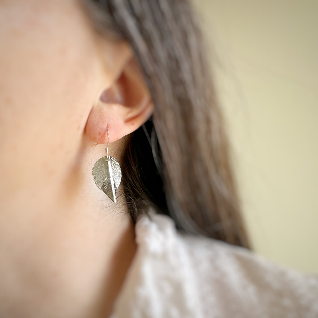 small hand formed and hammer textured leaves made of sterling silver.