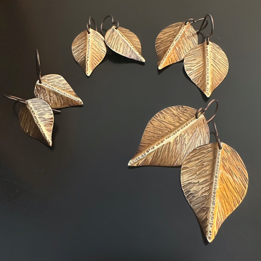 earrings that are hand formed and hammer textured leaves made of oxidized brass, choose from four sizes