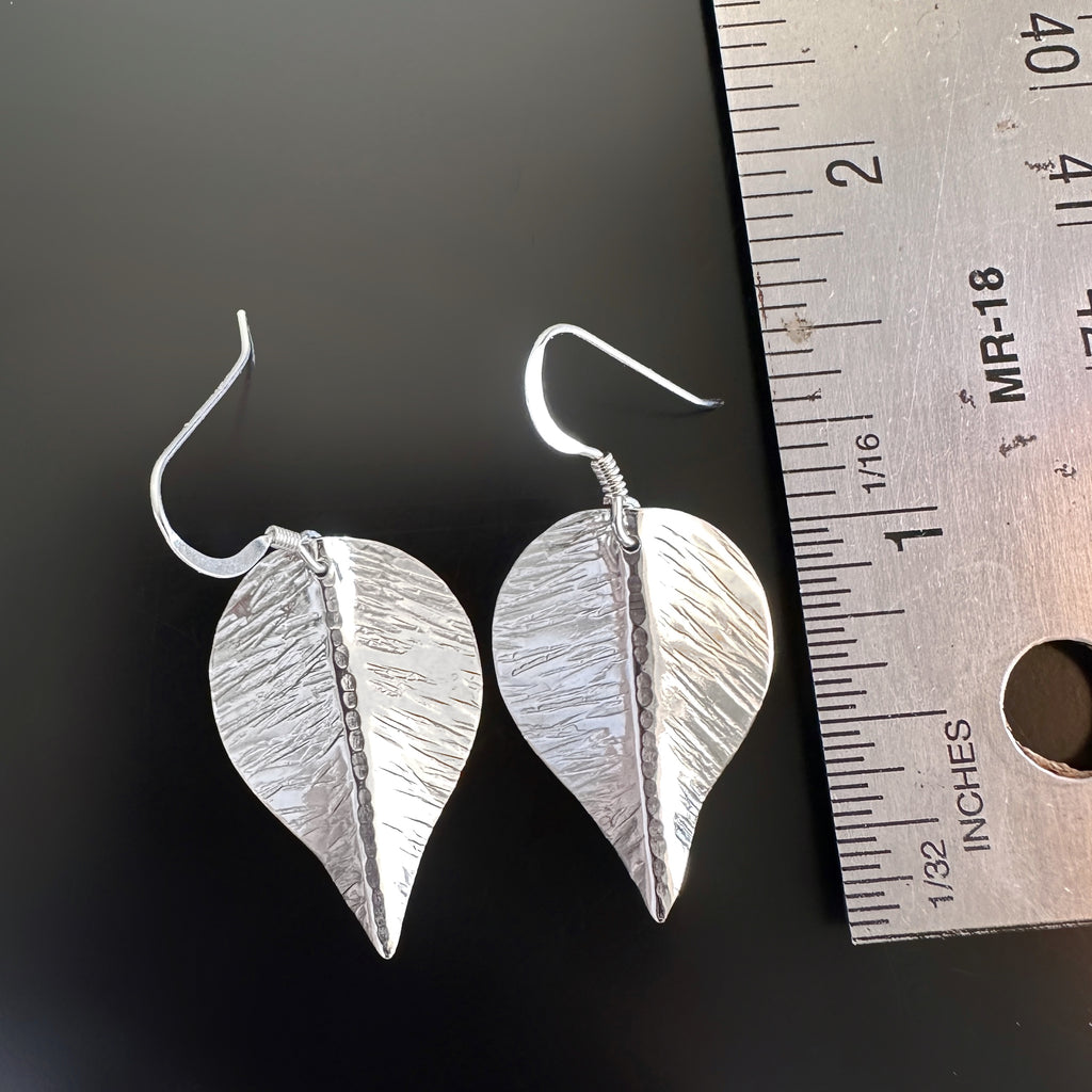 large hand formed and hammer textured leaves made of sterling silver measurement.