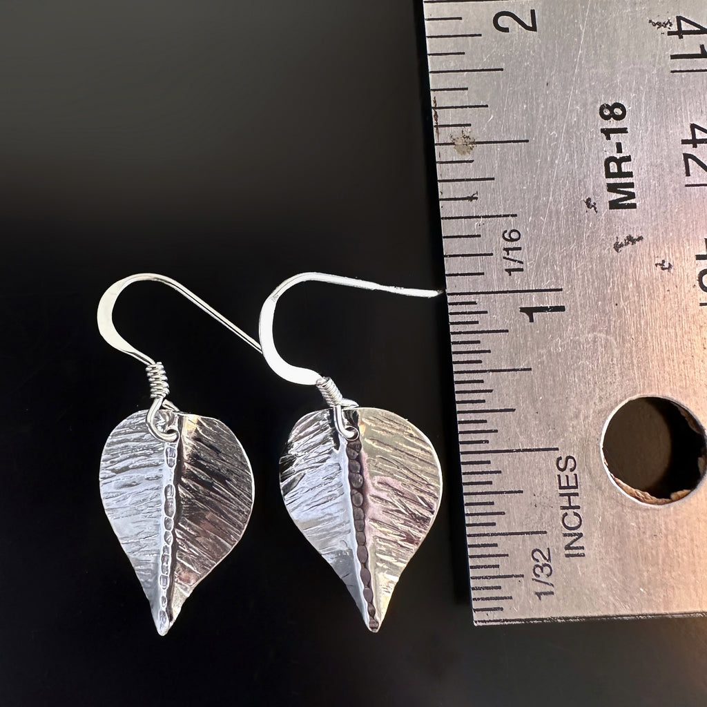 small hand formed and hammer textured leaves made of sterling silver measurement.