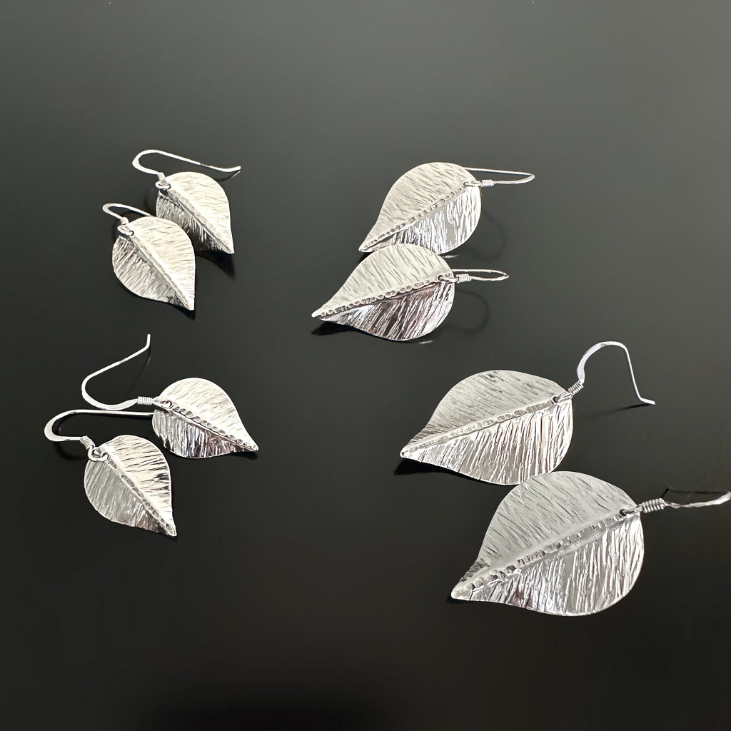 Hand formed and hammer textured leaves made of sterling silver available in four different sizes.