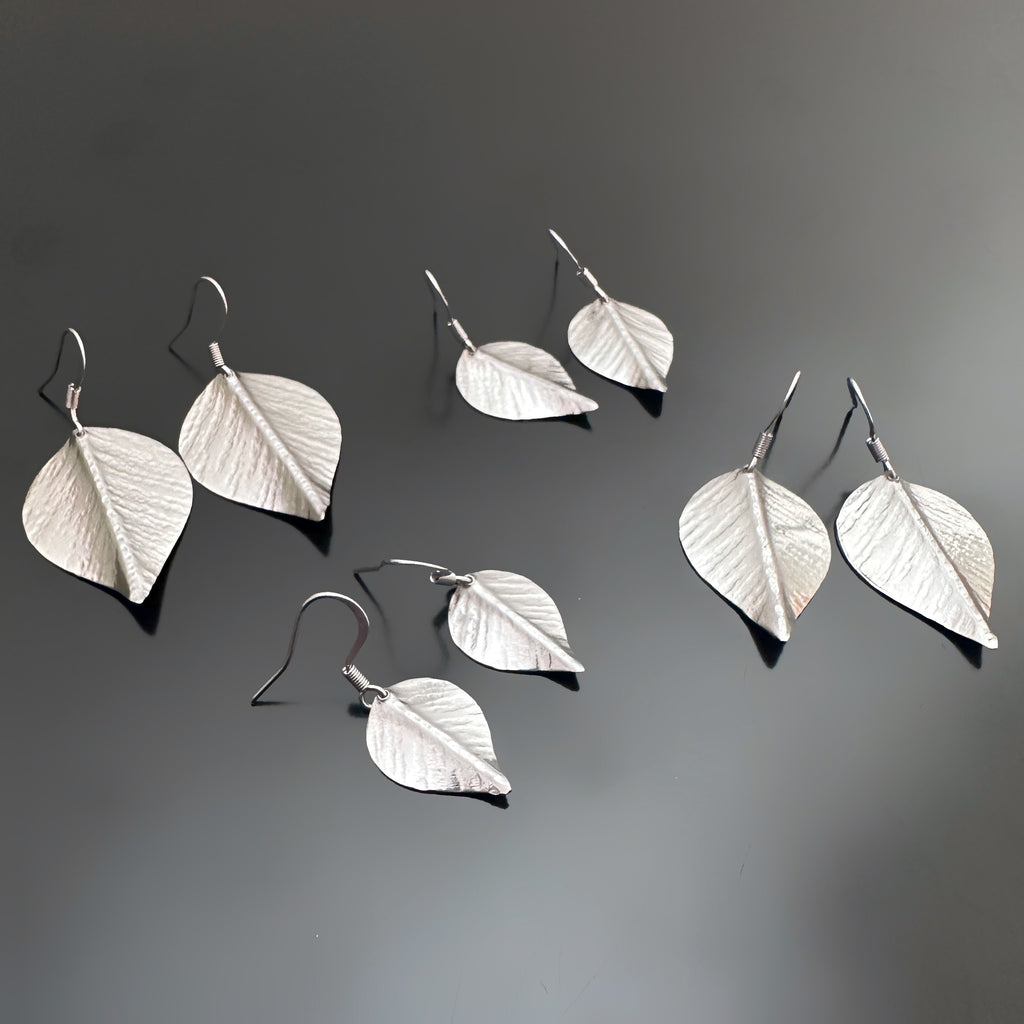 four size options of silvery surgical steel leaf shaped earrings on french hook ear wires.