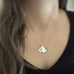 Medium sterling silver ginkgo leaf pendant necklace on model.