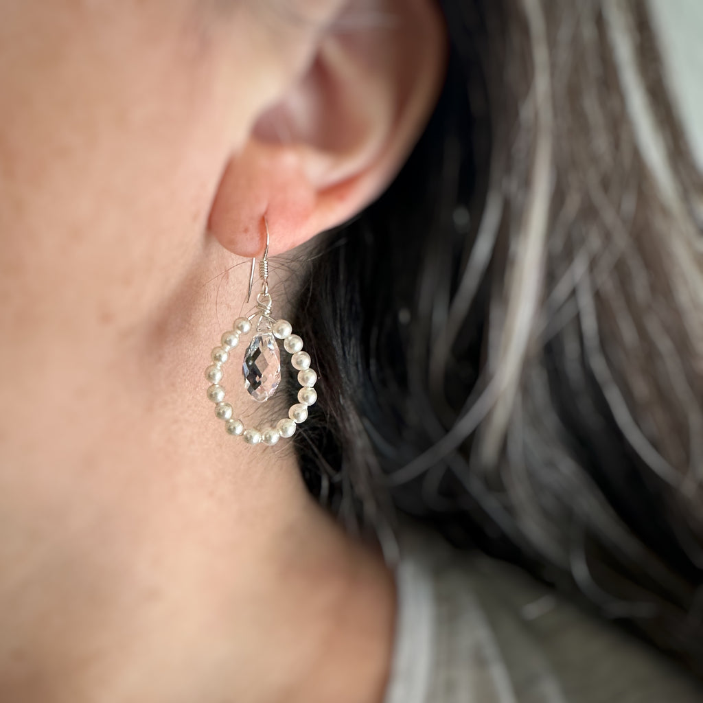 close up of the beaded teardrop white pearl and clear crystal drop earrings