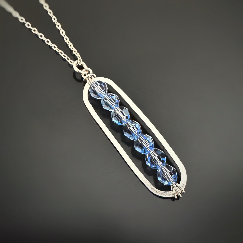 Paper Clip Style sterling silver pendant with light blue sapphire crystals
