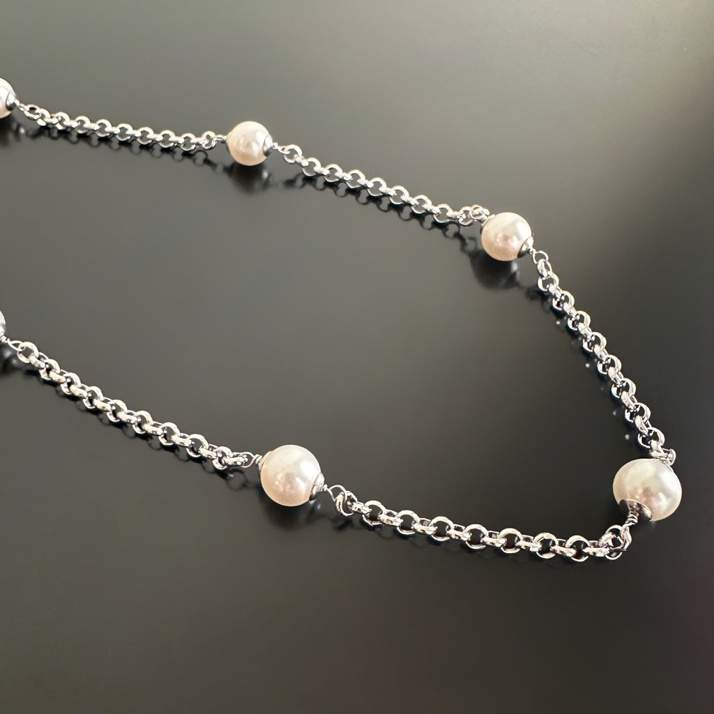 timeless pearl and chain design, 8mm white crystal pearls set within a 3.5mm surgical steel, rolo style chain.
