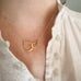 14k gold-filled necklace with interlocking teardrops pendant worn by a person