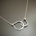 Two dainty handmade sterling silver interlocking teardrops on an adjustable length chain 16"-18"