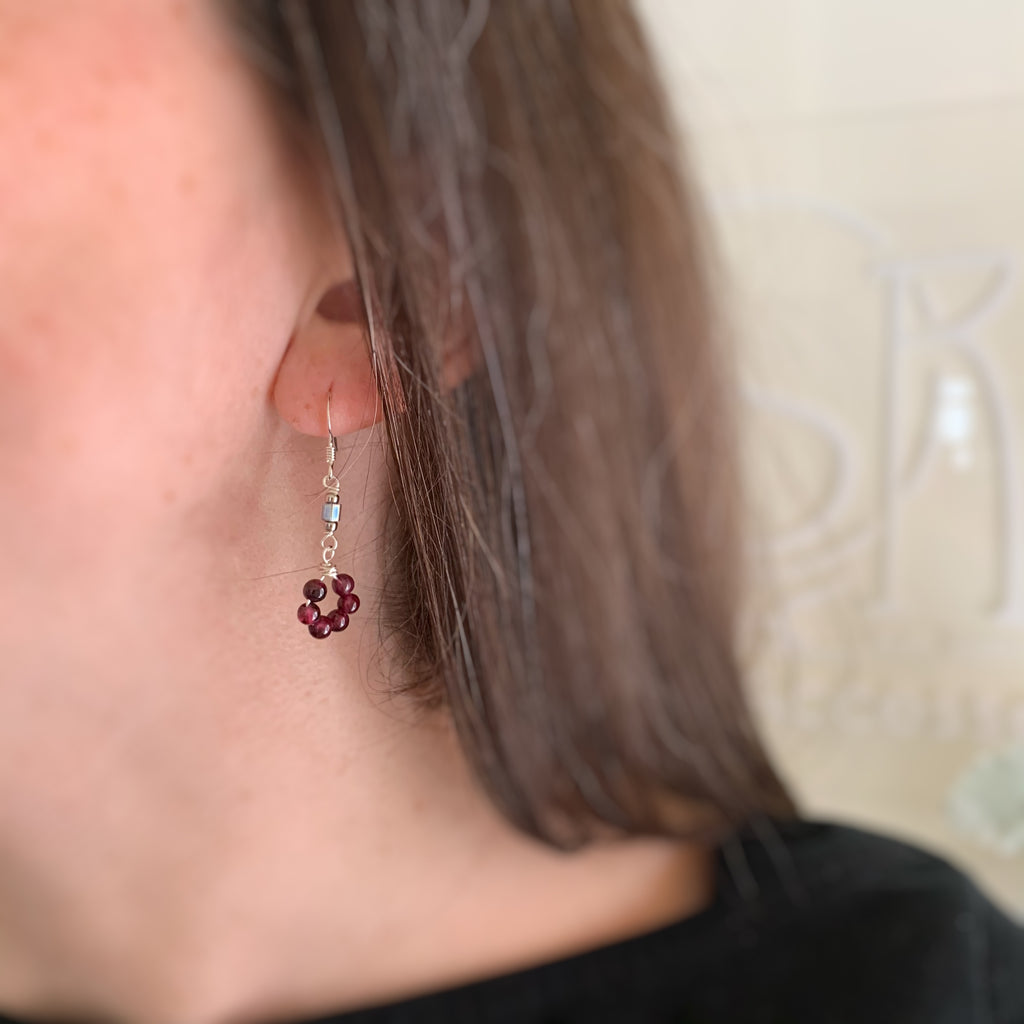cluster of garnet beads and an accent of iridescent glass earrings in sterling silver ear wires