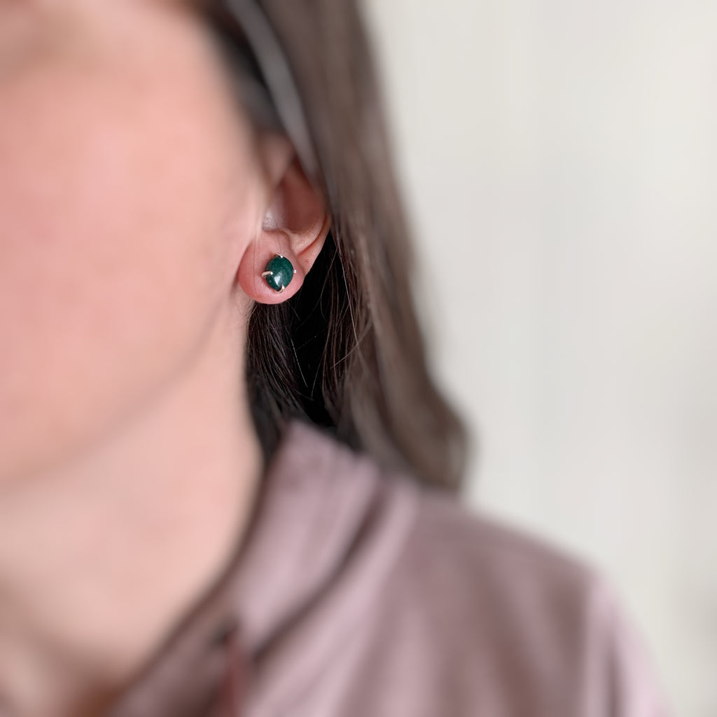 Dark green aventurine oval sterling silver stud earrings shown on model.