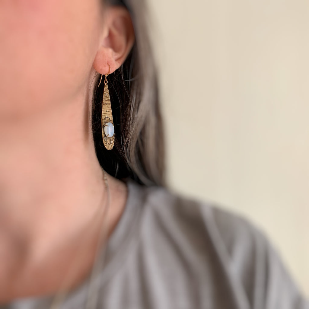 Long Golden Teardrop Earrings with Moon Glow Opal Glass and Lotus Flower Motif