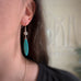 marquise shaped turquoise color earrings with silvery flower bead
