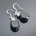 Black glass faceted nugget drop earrings with silvery accents and surgical steel ear wires.