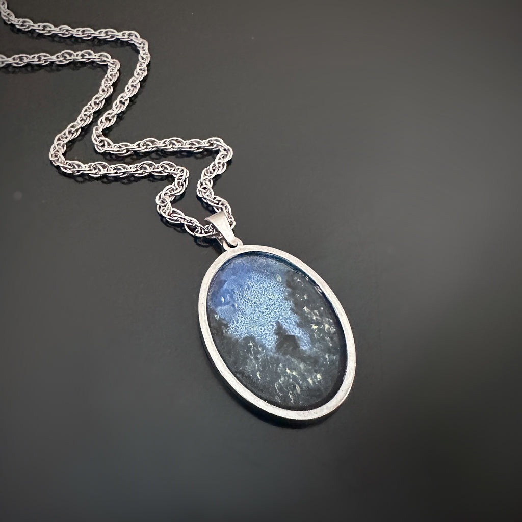 Silver color oval shaped pendant, hand painted depicting Lightning Bugs in the Midnight Pines.