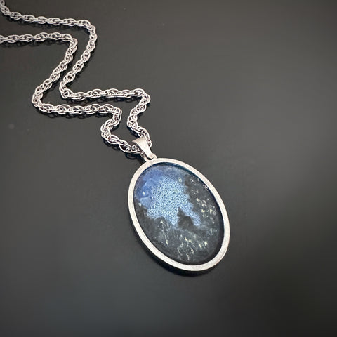 Silver color oval shaped pendant, hand painted depicting Lightning Bugs in the Midnight Pines.