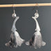 Large silver earrings in a trumpet-like shaped flower with engraved details.  Surgical steel french hook style ear wires.
