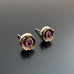 Handmade brass flowers with small round garnets set in the center. Surgical steel post earrings