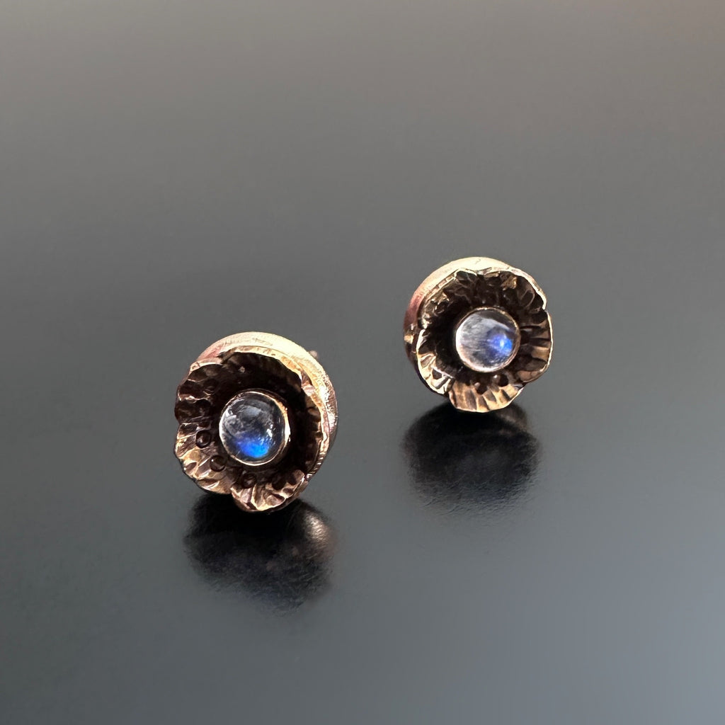 Handmade brass flowers with small round moonstones set in the center. Surgical steel post earrings