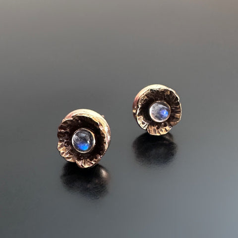 Handmade brass flowers with small round moonstones set in the center. Surgical steel post earrings