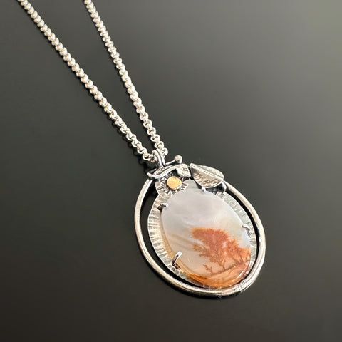 Handmade sterling silver pendant with a dendritic agate stone that has the appearance of a scene depicting a tree, field and sky.  It is a completely natural stone and truly one of a kind.