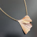 Golden oxidized brass necklace with a ginkgo leaf shaped pendant on a heavy rolo style chain