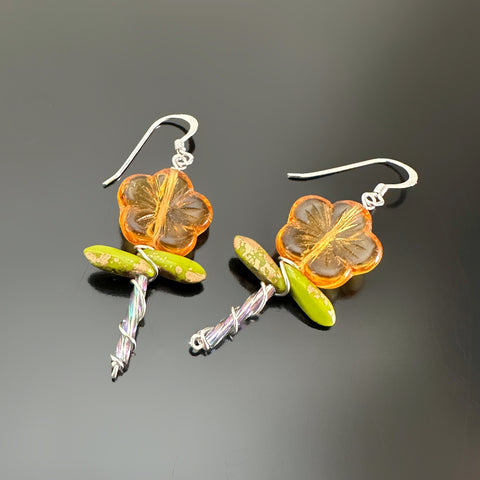 Amber color Czech glass flower beaded earrings with stem and two leaves.