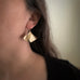 Large 14k gold filled ginkgo leaf earrings shown on model.