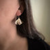 Large oxidized brass ginkgo leaf earrings shown on model.