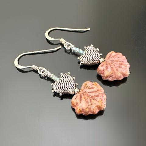 Coral colored Czech glass leaf beaded earring with a silvery heart on top.
