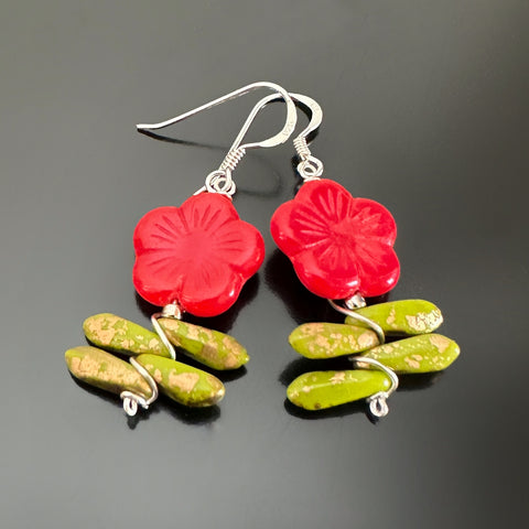 Red colored Czech glass flower beaded earrings with leaves.