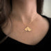 Medium 14k gold filled ginkgo leaf pendant necklace shown on model.