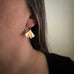 Medium 14k gold filled ginkgo leaf earrings shown on model.