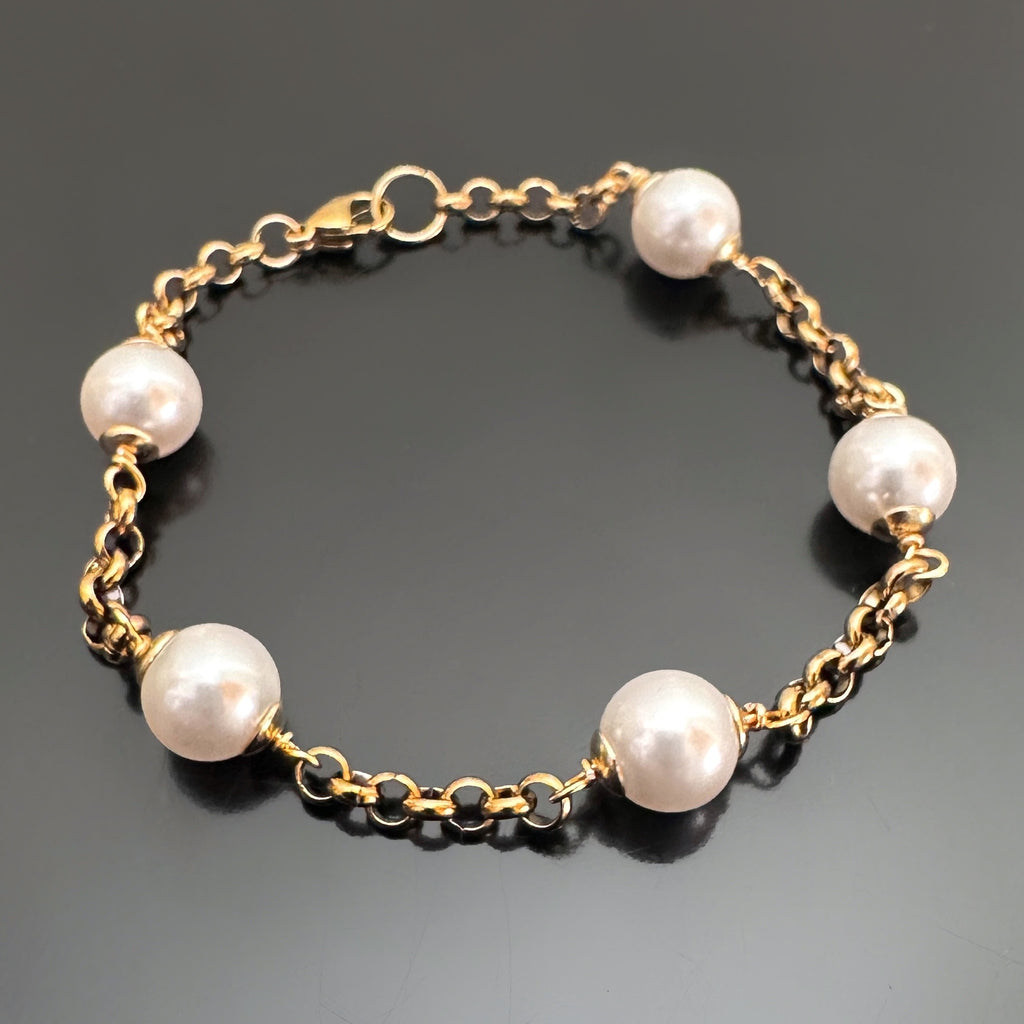8mm white crystal pearls are stationed evenly throughout a gold tone heavy rolo style chain.