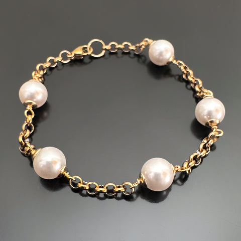 8mm white crystal pearls are stationed evenly throughout a gold tone heavy rolo style chain.