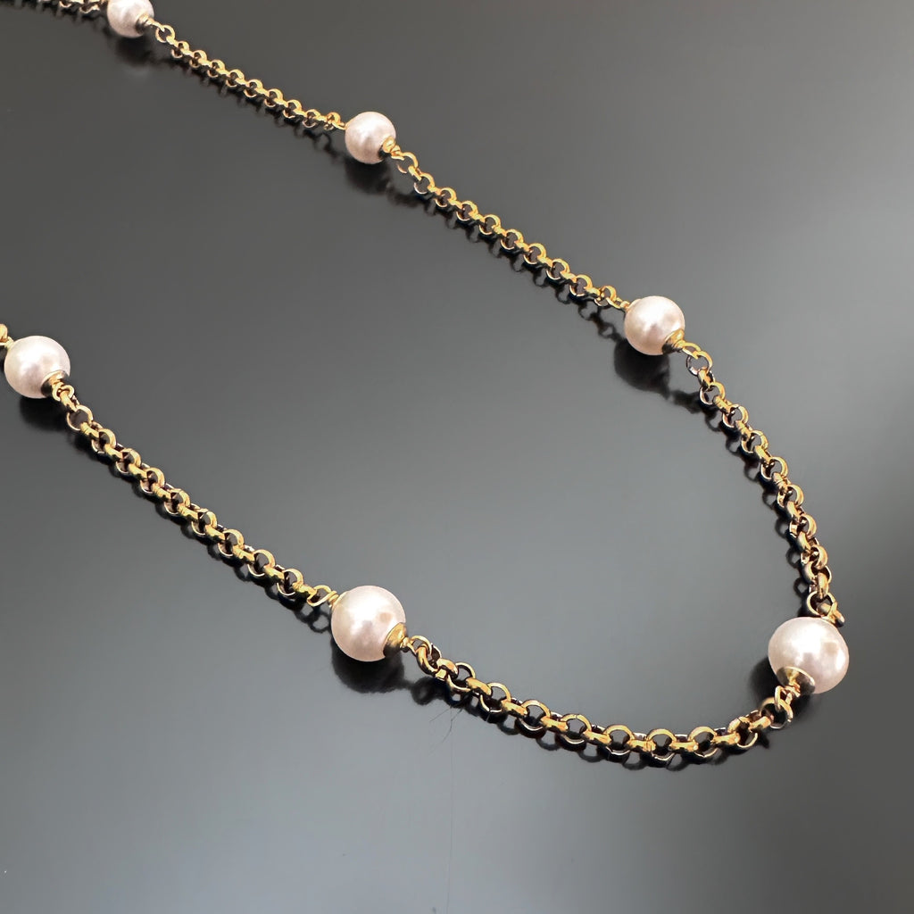 8mm white crystal pearls are stationed evenly throughout a gold tone heavy rolo style chain.