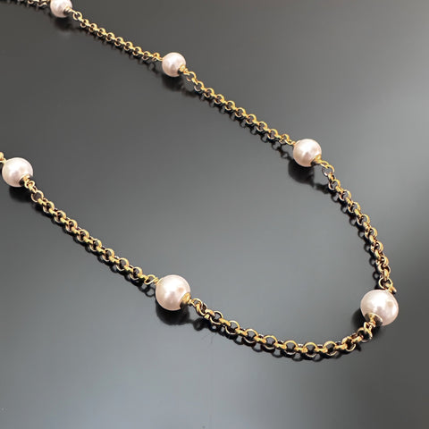 8mm white crystal pearls are stationed evenly throughout a gold tone heavy rolo style chain.