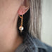 8mm white crystal pearls are stationed on a gold tone heavy rolo style chain. shown as worn.