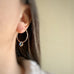 handmade sterling silver hoop earrings with a small blue Austrian crystal teardrop dangle.
