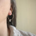 handmade sterling silver hoop earrings with a small clear Austrian crystal teardrop dangle.
