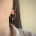 handmade sterling silver hoop earrings with a small tanzanite purple Austrian crystal teardrop dangle.