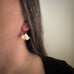 Small 14k gold filled ginkgo leaf earrings shown on model.